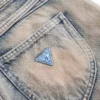 Denim broek met vetersluiting en uitlopende pijpen